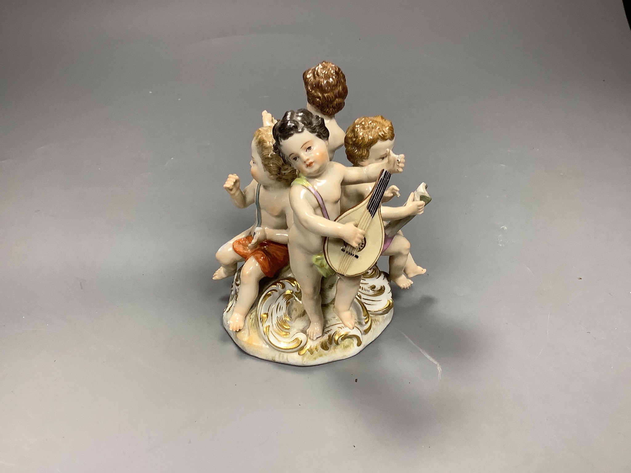 A Meissen group of four putti musicians, late 19th century, 11 cm high, losses
